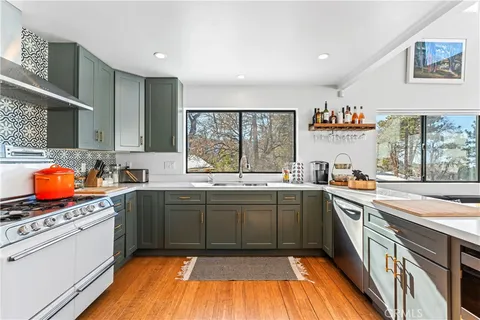 a kitchen with stainless steel appliances granite countertop a stove and a sink