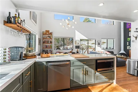 a kitchen with a sink and chairs