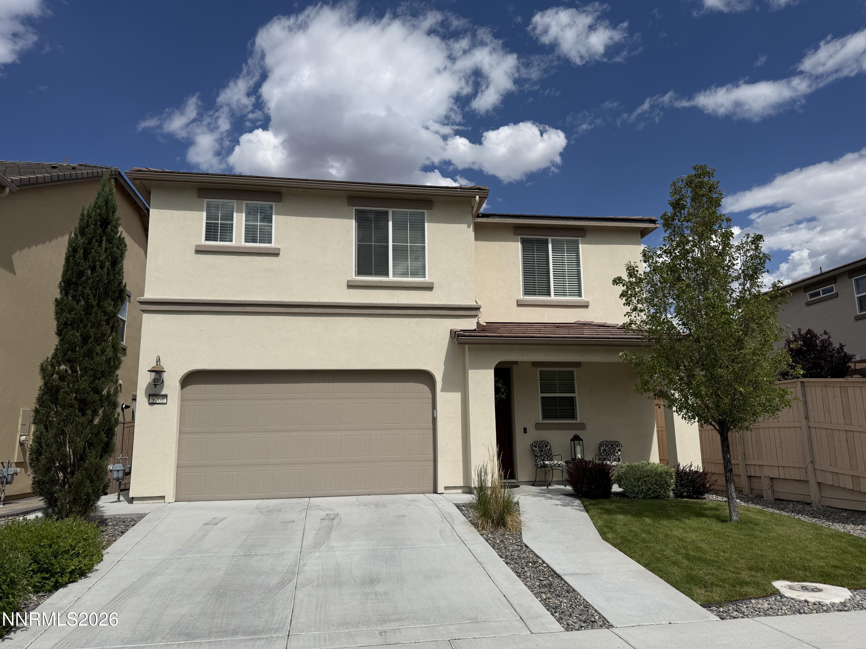 9766 Pachuca Drive Reno, NV 89521 - Photo 2 of 59 a front view of a house with a garden and entryway