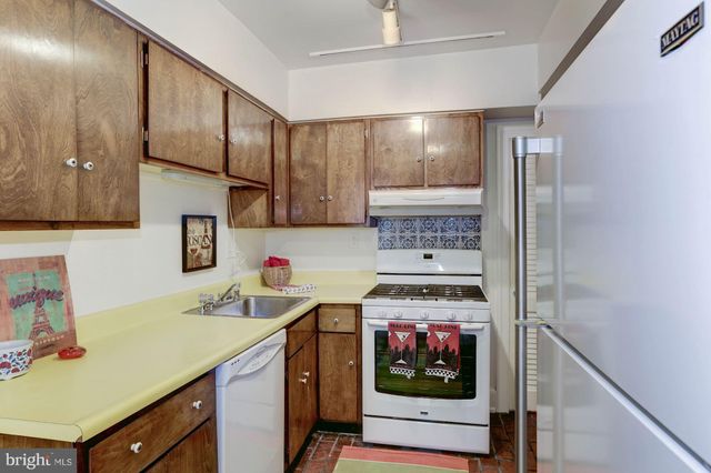 a kitchen with a sink cabinets and window
