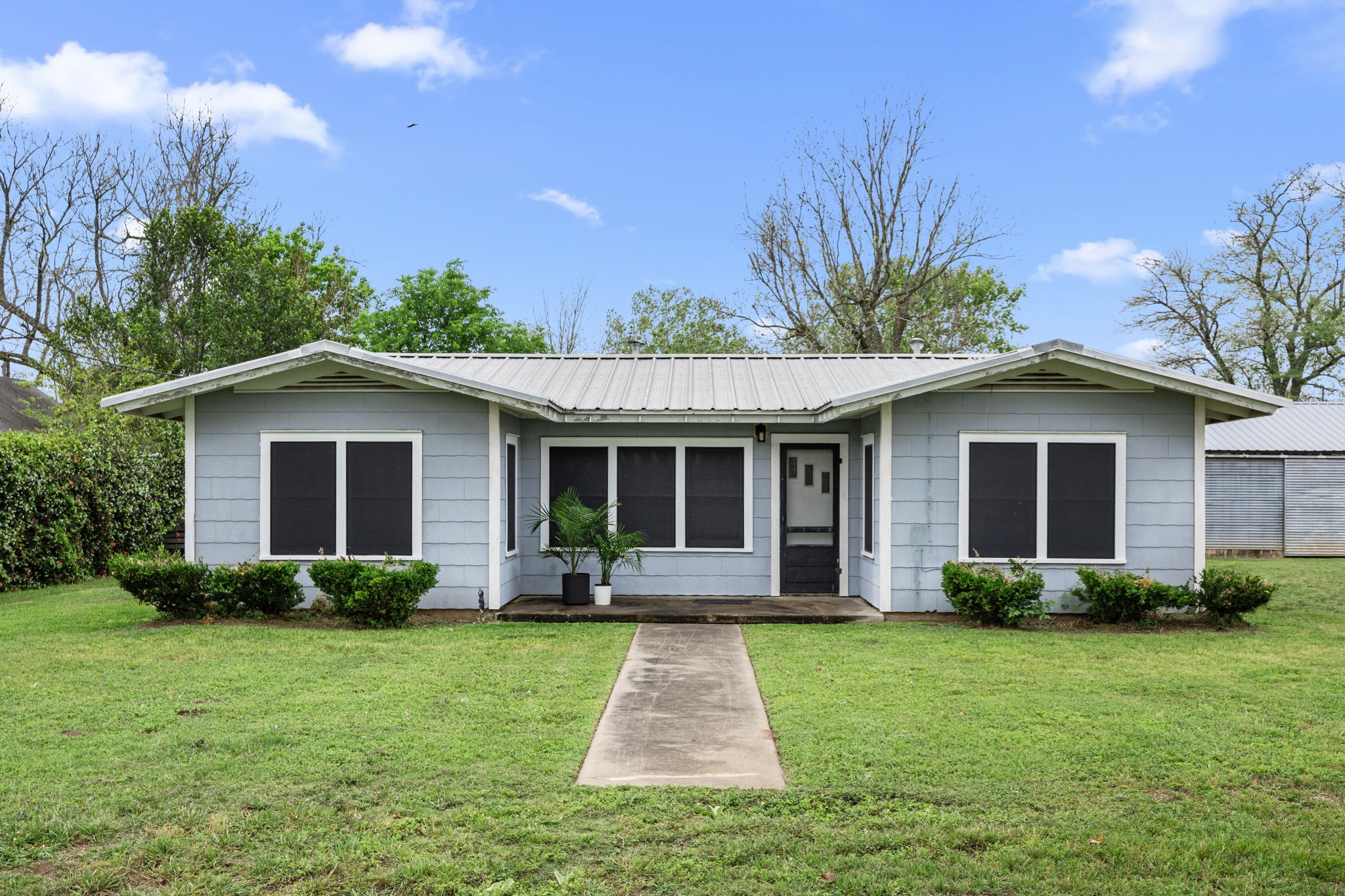 a front view of house with yard and green space