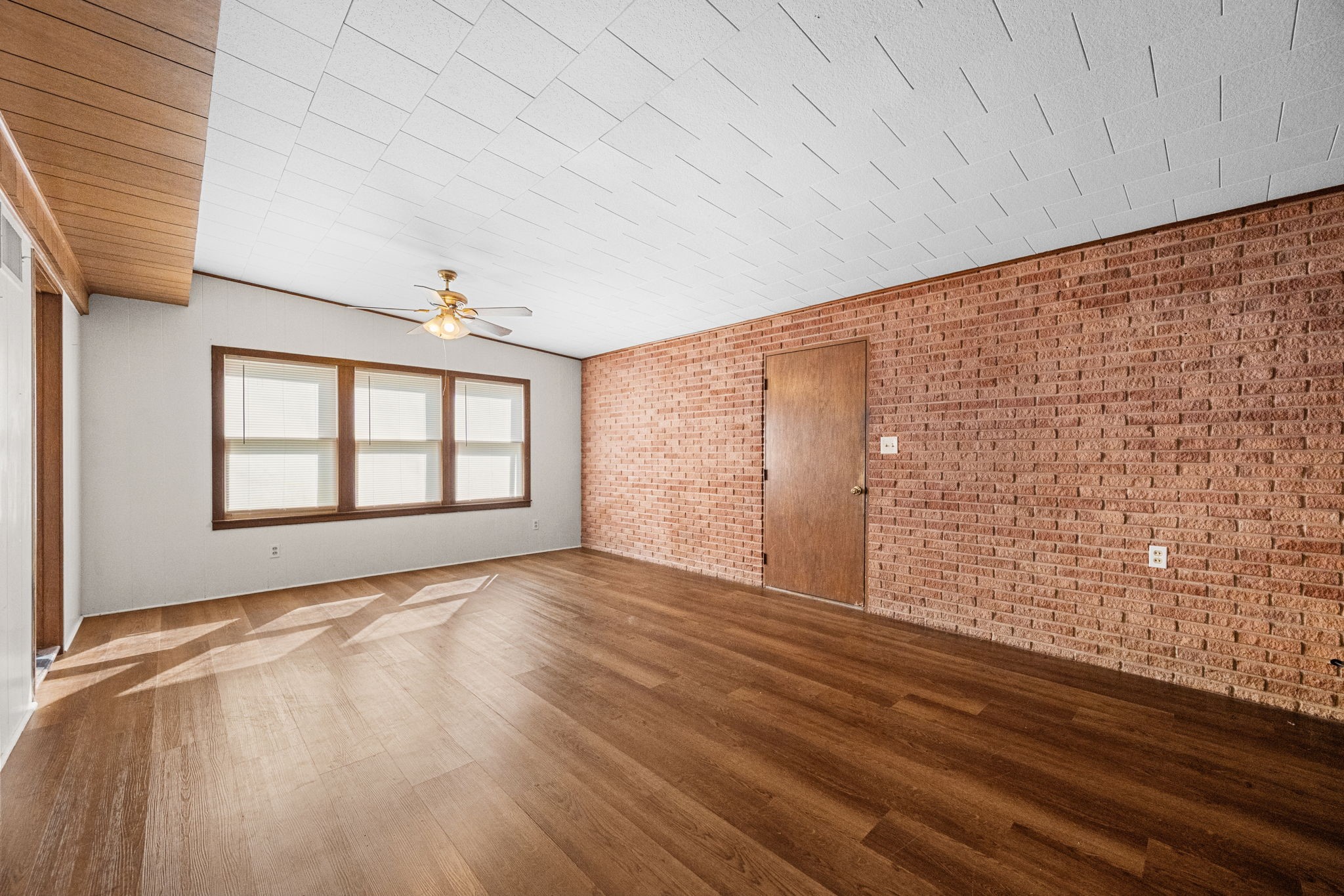 209 3rd Avenue Columbus, TX 78934 - Photo 12 of 34 a view of an empty room with a window and wooden floor