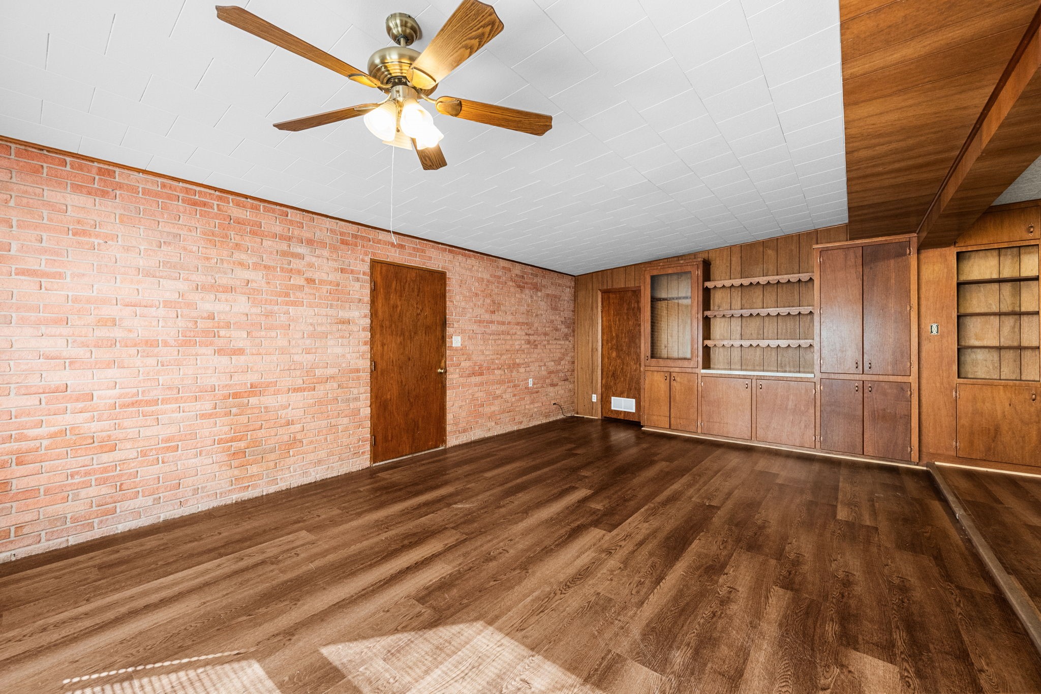 209 3rd Avenue Columbus, TX 78934 - Photo 13 of 34 a view of an empty room with a window and wooden floor