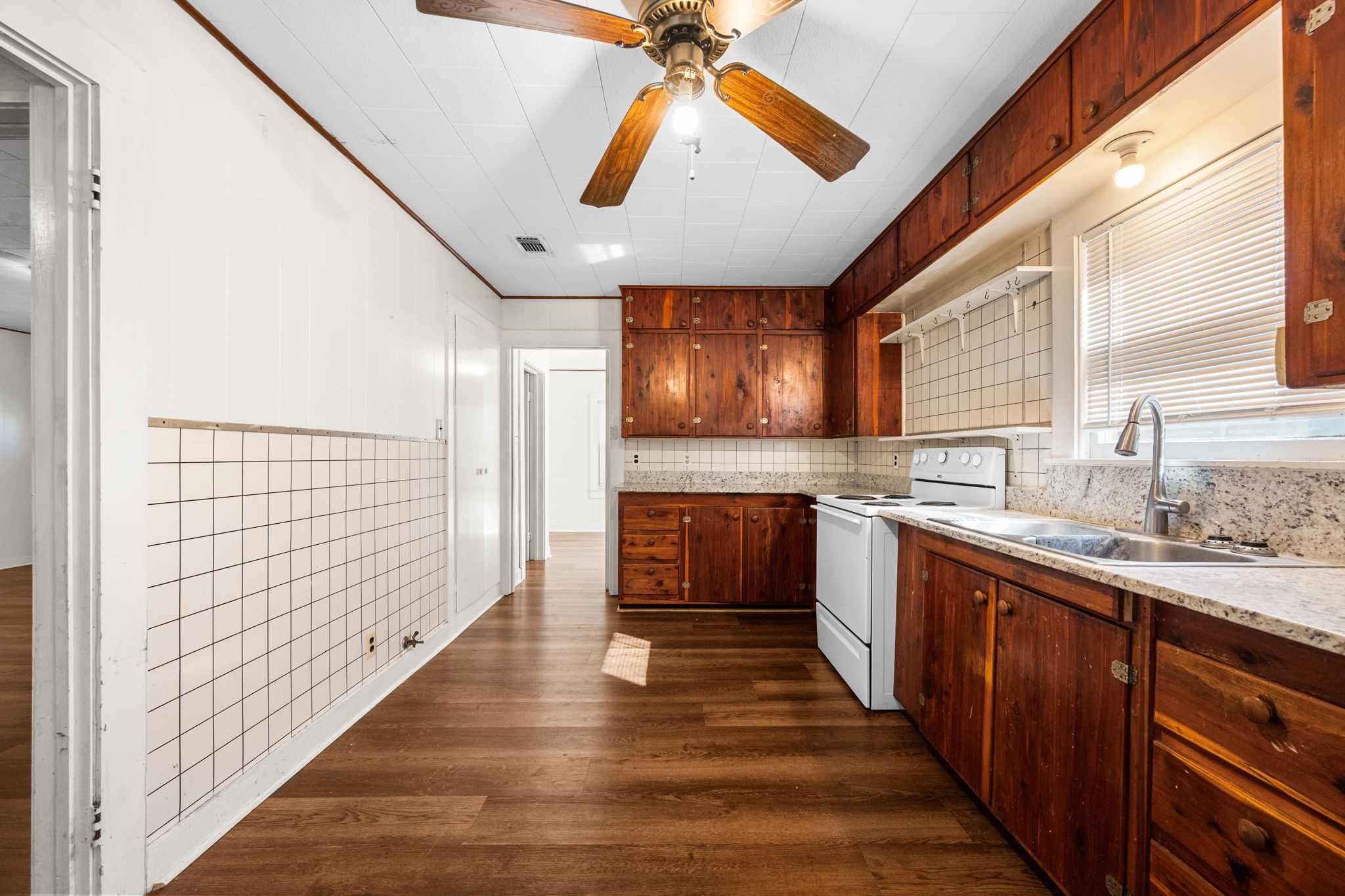 209 3rd Avenue Columbus, TX 78934 - Photo 17 of 34 a kitchen with stainless steel appliances sink cabinets and wooden floor