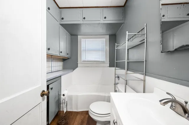 a bathroom with a sink a toilet and tub