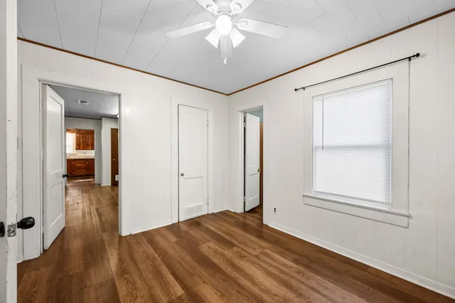 wooden floor in an empty room with a window