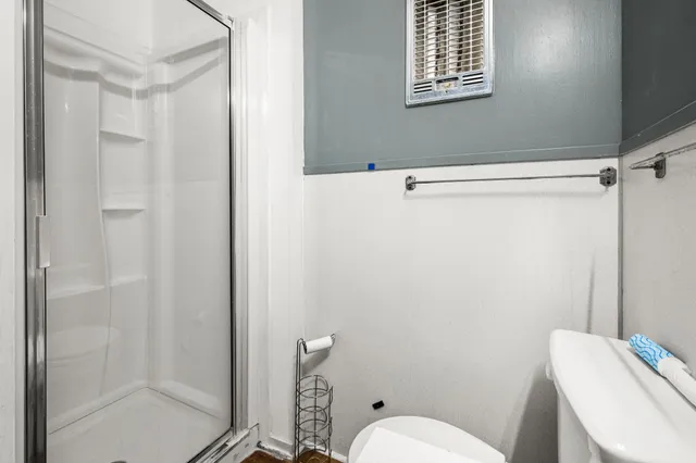 a white toilet sitting next to a bathroom sink