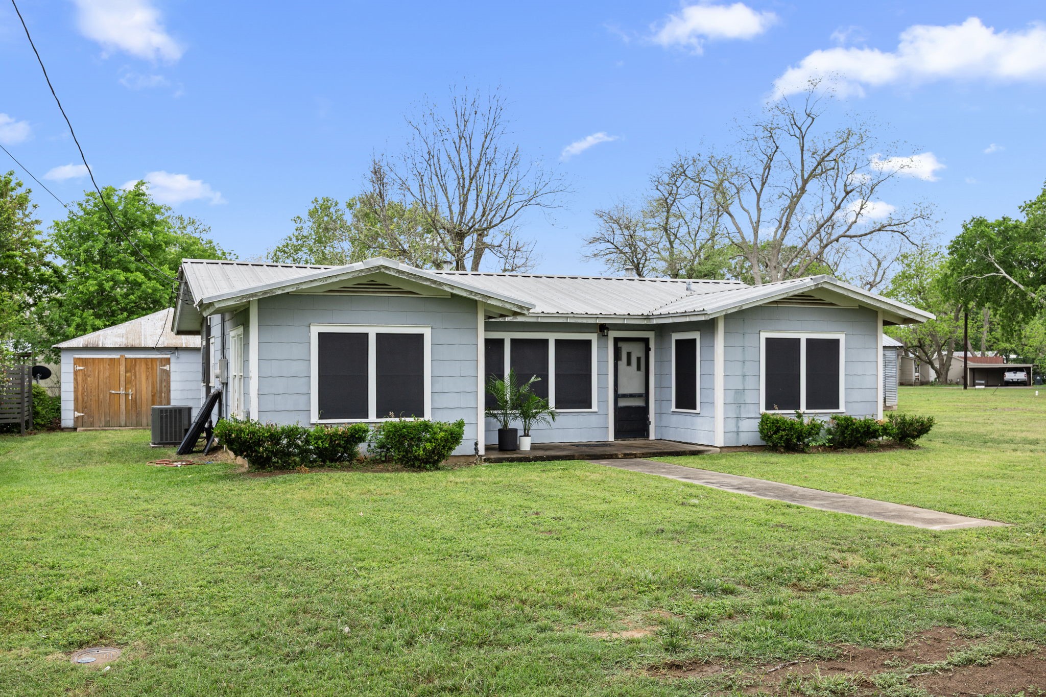 209 3rd Avenue Columbus, TX 78934 - Photo 3 of 34 a front view of a house with a garden and trees