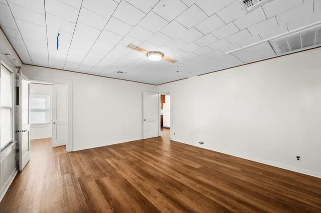 a view of empty room with wooden floor