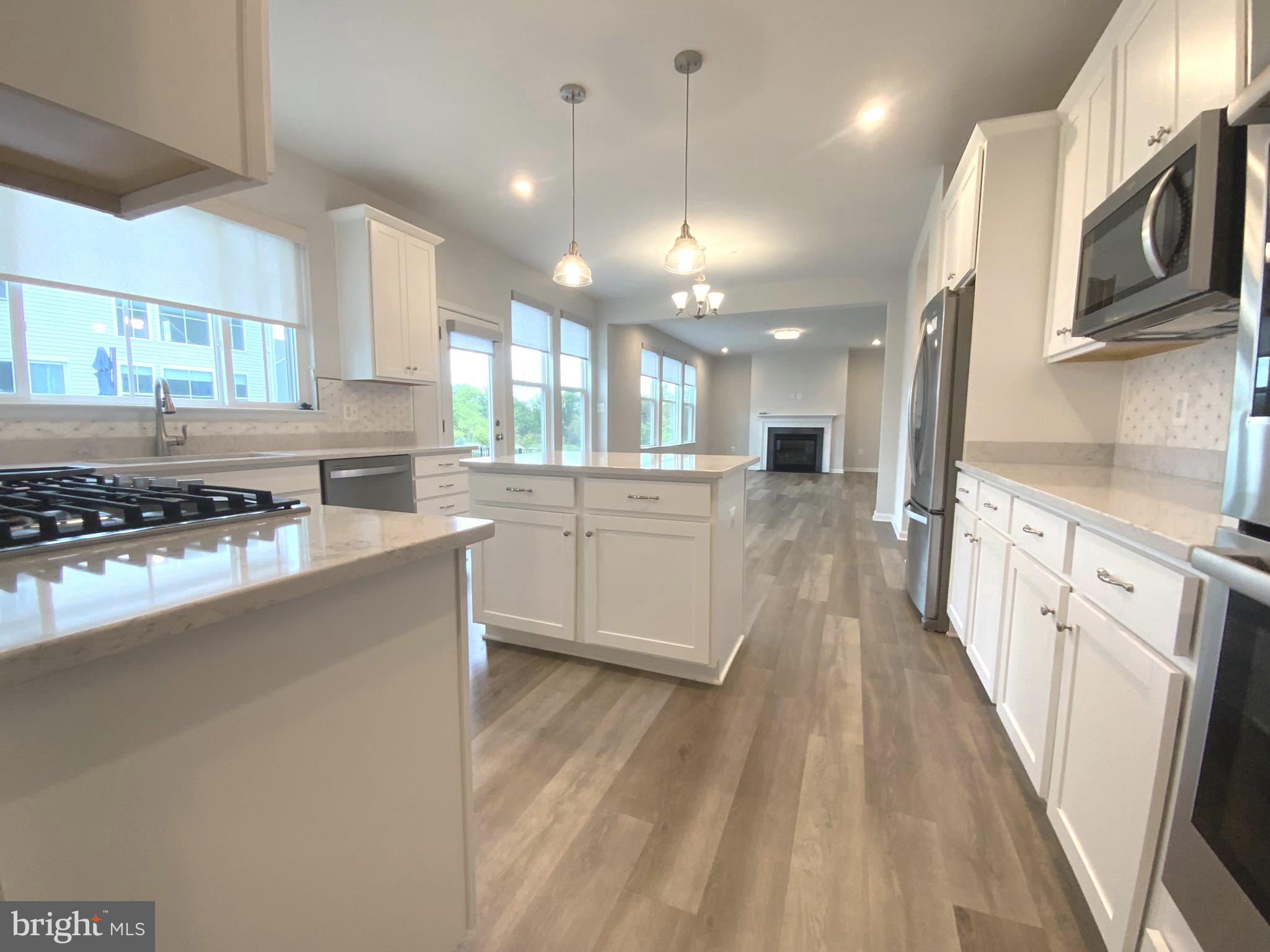 5763 Hawk Ridge Road Frederick, MD 21704 - Photo 27 of 73 a large kitchen with stainless steel appliances lots of counter space and wooden floors