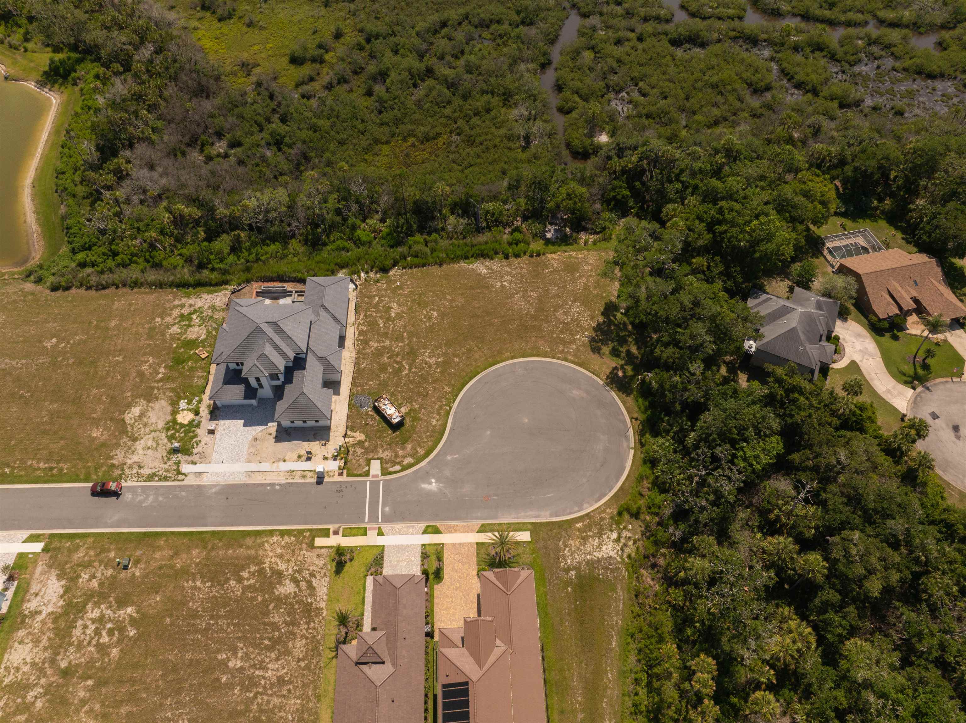 5 Coronado Road Flagler Beach, FL 32136 - Photo 8 of 18 an aerial view of a house with outdoor space and trees all around