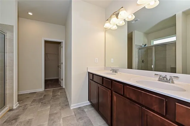 a bathroom with a glass shower door and a window