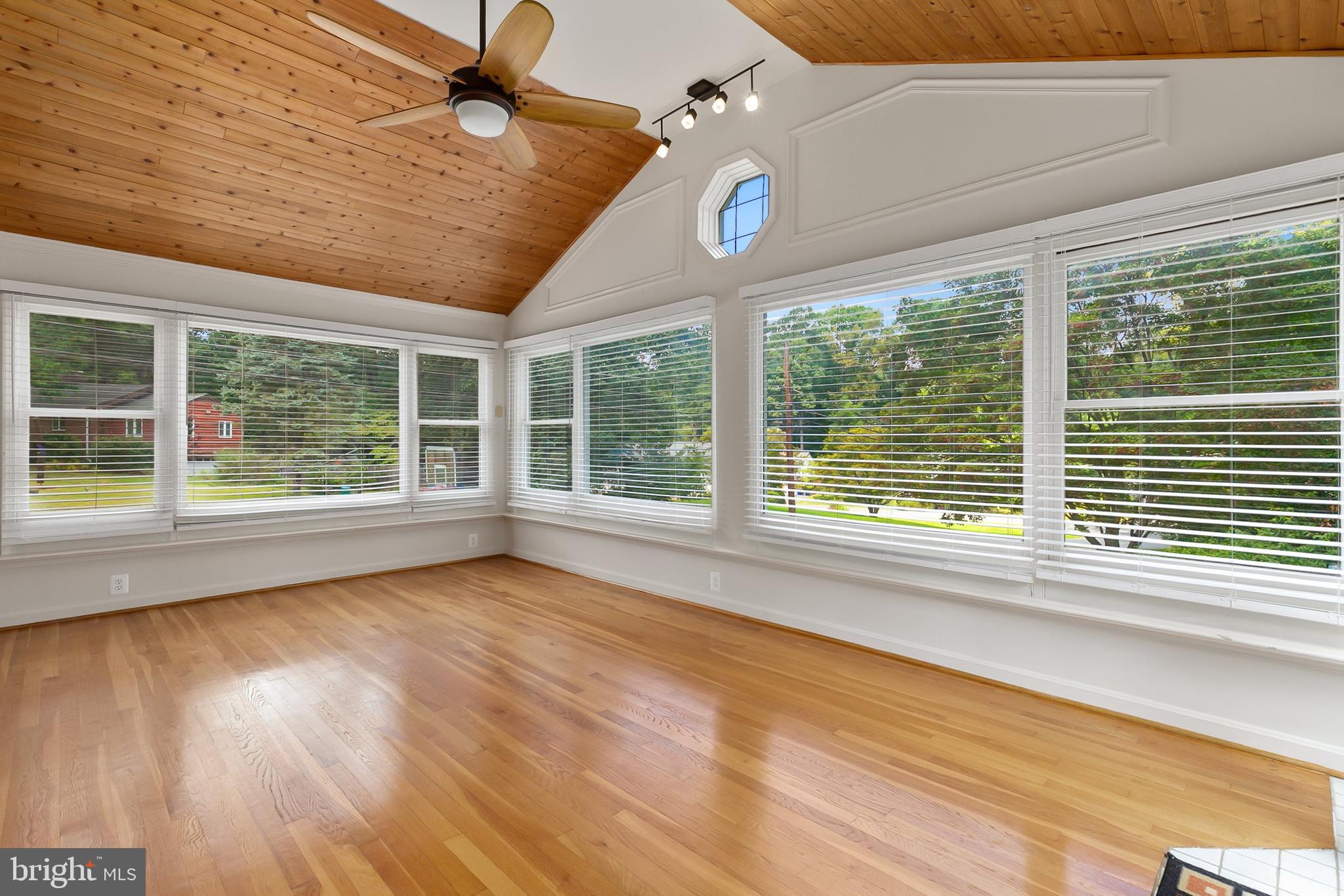 10601 Kinloch Road Silver Spring, MD 20903 - Photo 11 of 47 a view of an empty room with wooden floor and a window