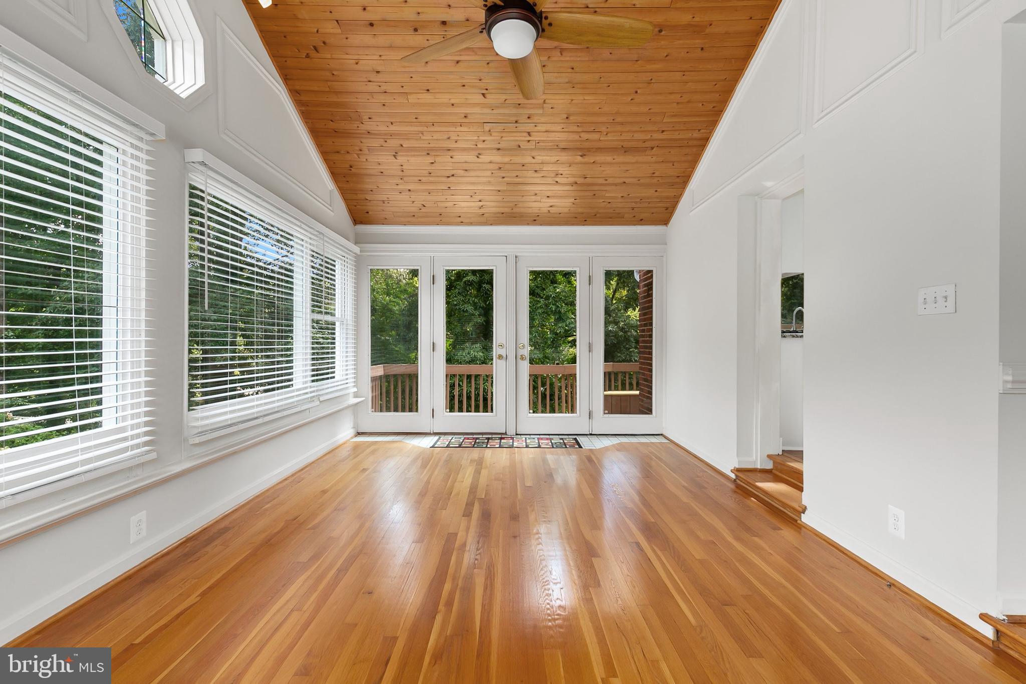 10601 Kinloch Road Silver Spring, MD 20903 - Photo 12 of 47 a view of an empty room with wooden floor and a window