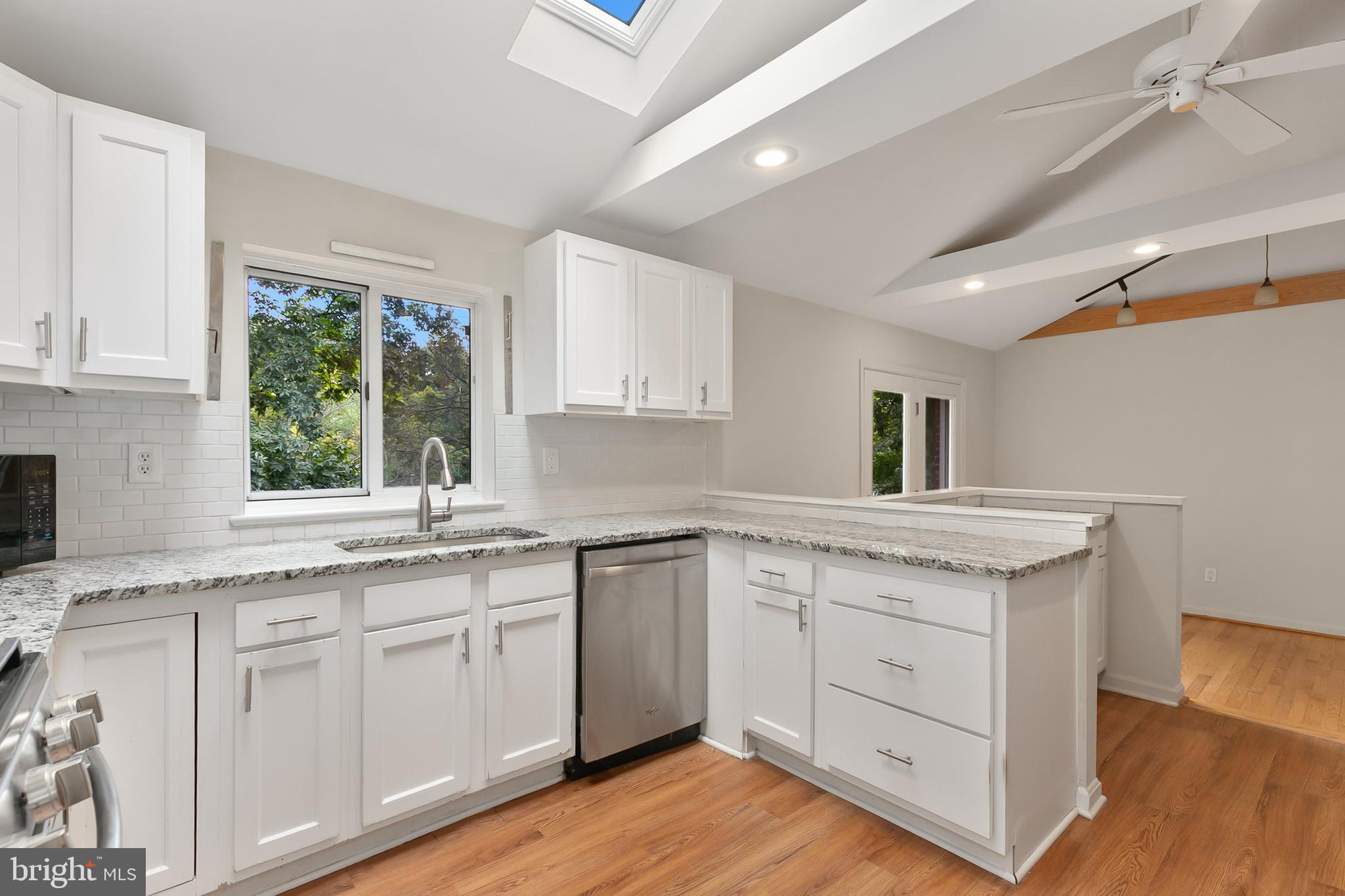 10601 Kinloch Road Silver Spring, MD 20903 - Photo 17 of 47 a kitchen with white cabinets and a window