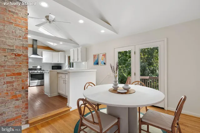 a kitchen with a table chairs and white appliances