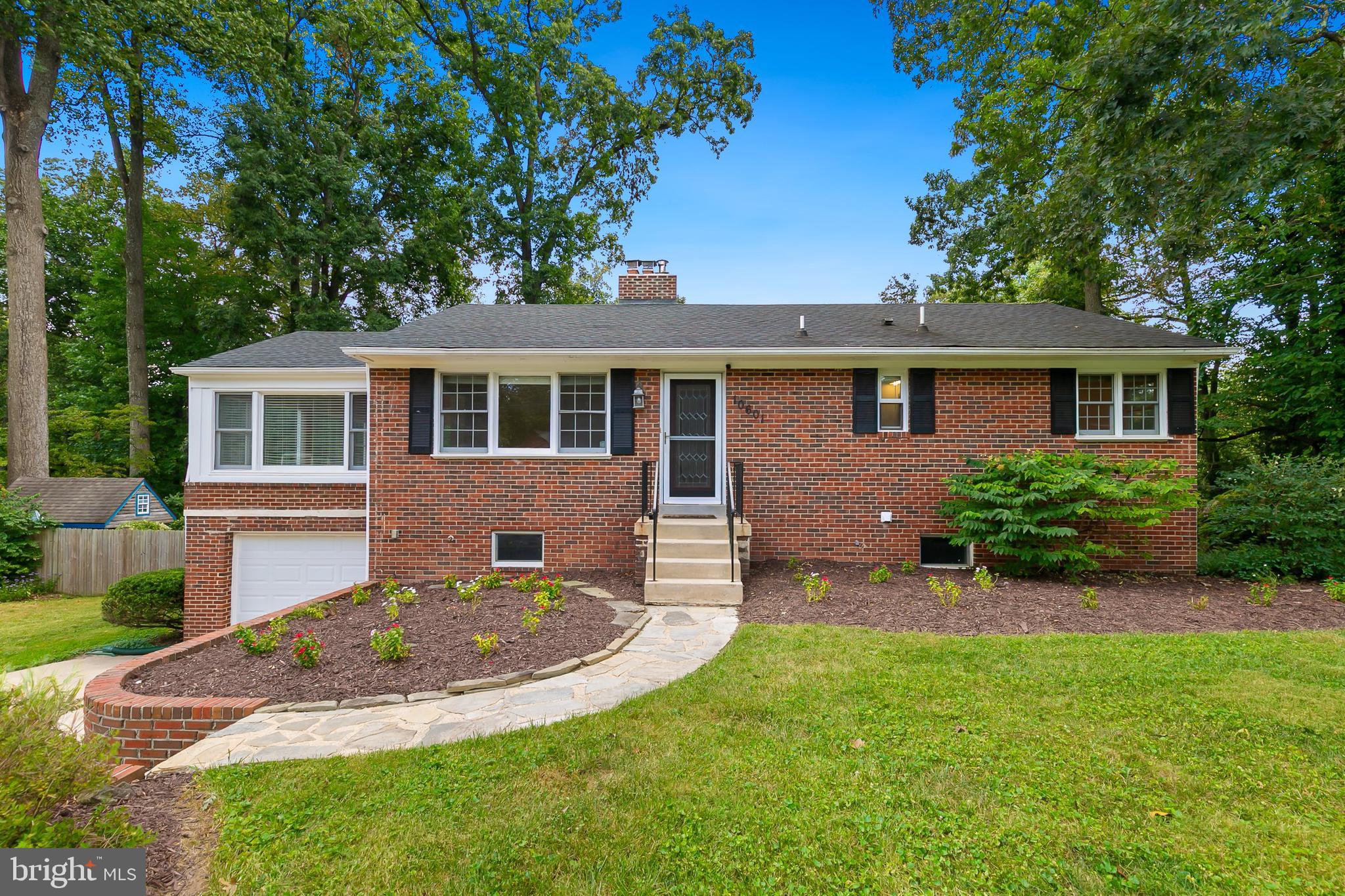 10601 Kinloch Road Silver Spring, MD 20903 - Photo 2 of 47 a front view of a house with a yard