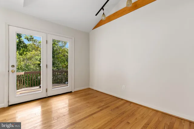 a view of a room with wooden floor and window