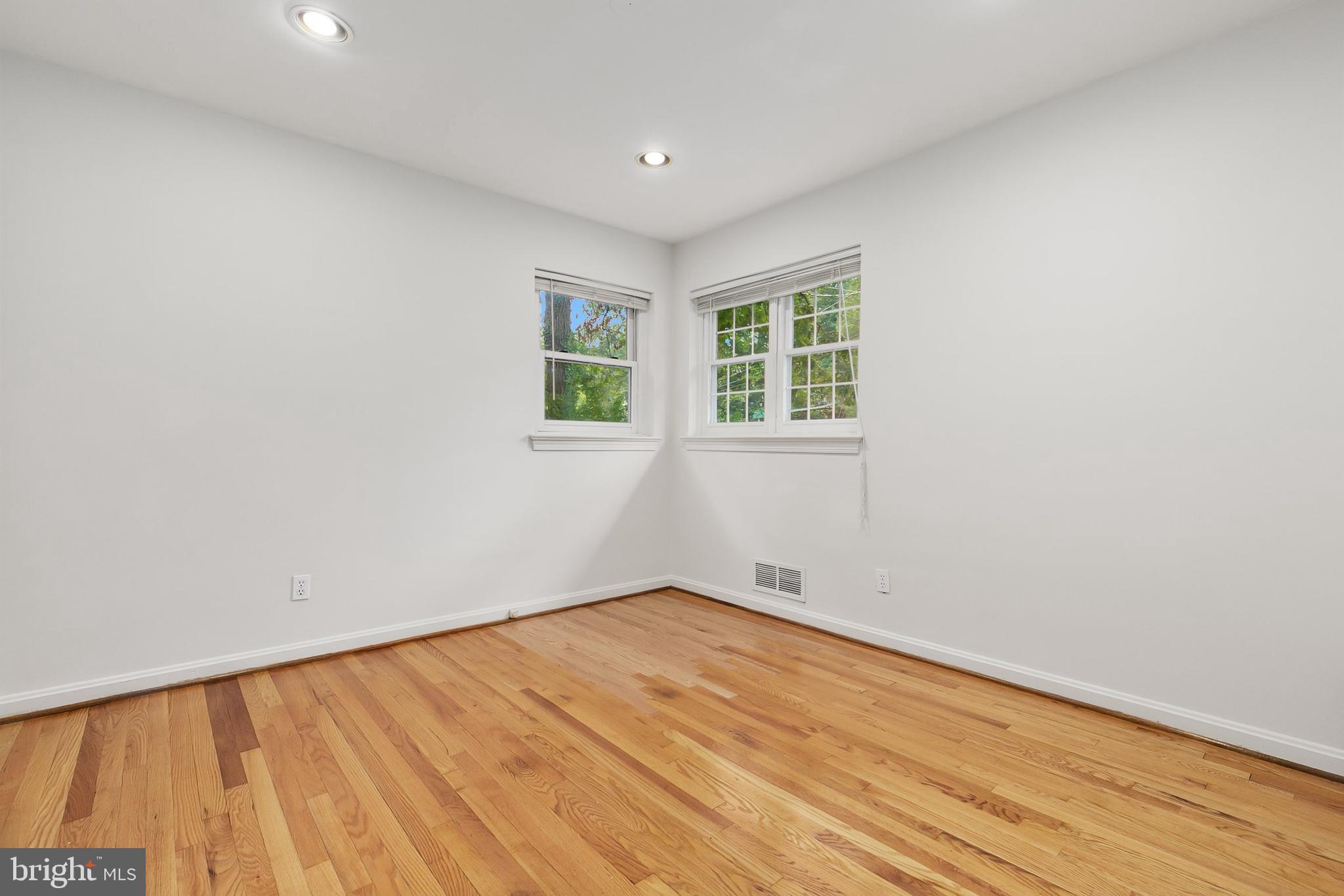 10601 Kinloch Road Silver Spring, MD 20903 - Photo 23 of 47 an empty room with wooden floor and windows
