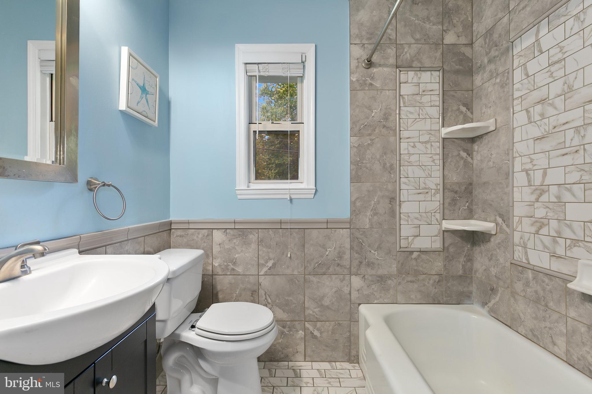 10601 Kinloch Road Silver Spring, MD 20903 - Photo 24 of 47 a bathroom with a sink toilet and shower