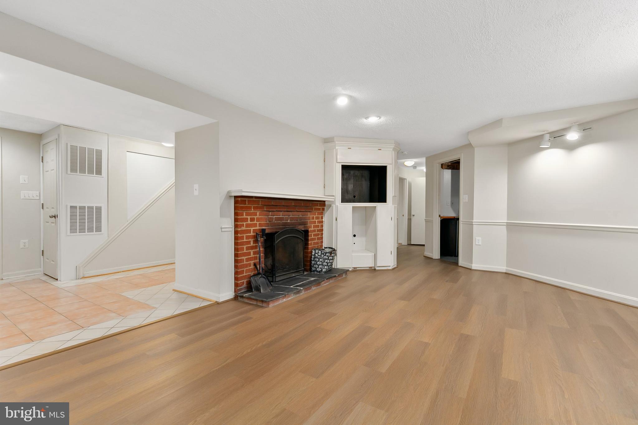 10601 Kinloch Road Silver Spring, MD 20903 - Photo 26 of 47 a view of an empty room with a fireplace and a window