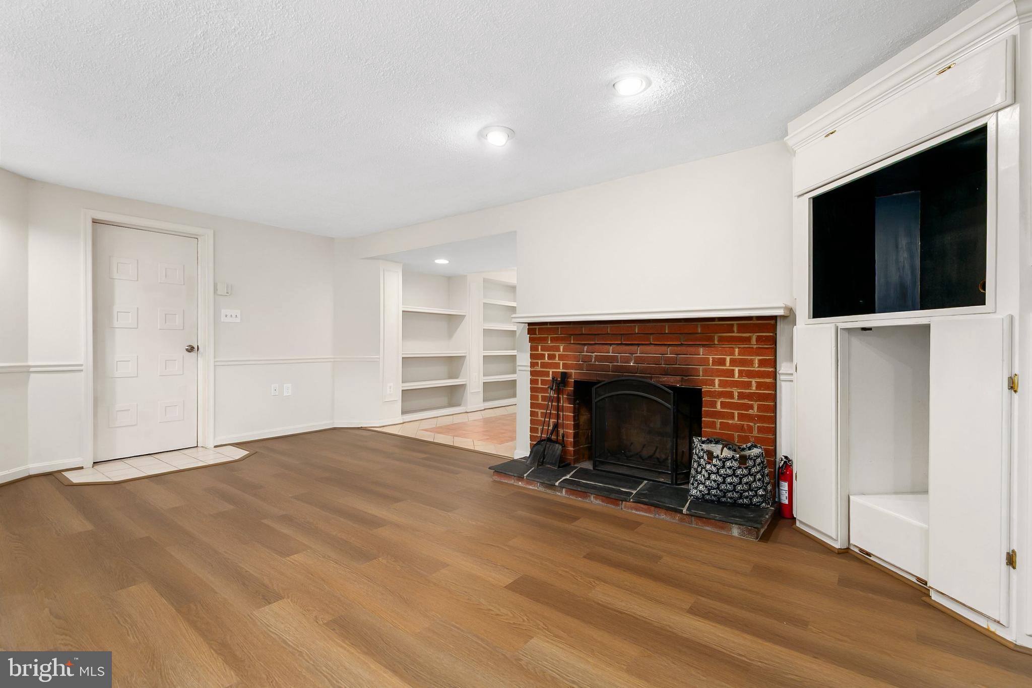 10601 Kinloch Road Silver Spring, MD 20903 - Photo 27 of 47 a view of an empty room with a fireplace and a window