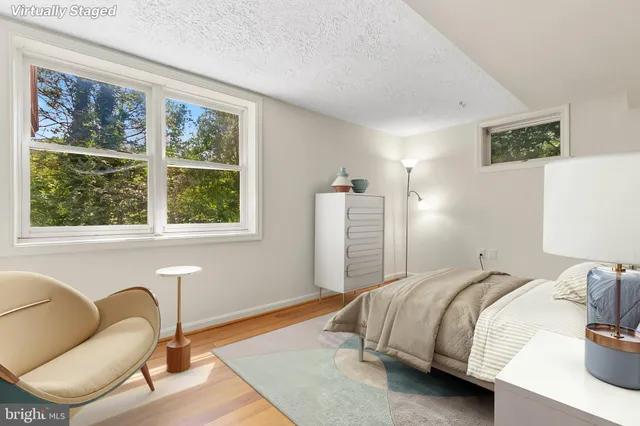 a bedroom with bed and a window