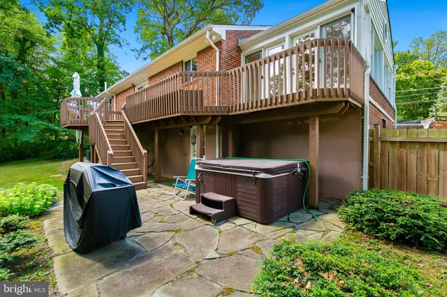 a view of a chairs and table in the back yard of the house