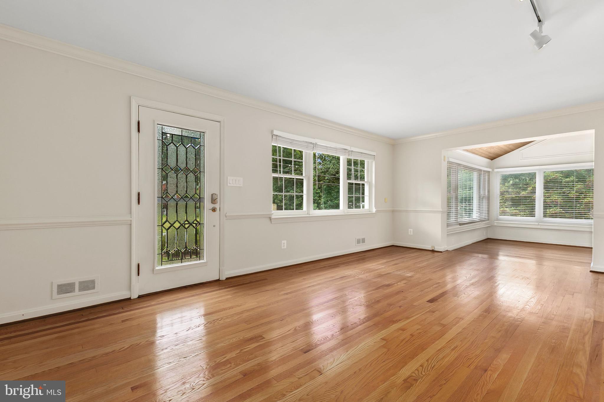10601 Kinloch Road Silver Spring, MD 20903 - Photo 4 of 47 an empty room with wooden floor and windows