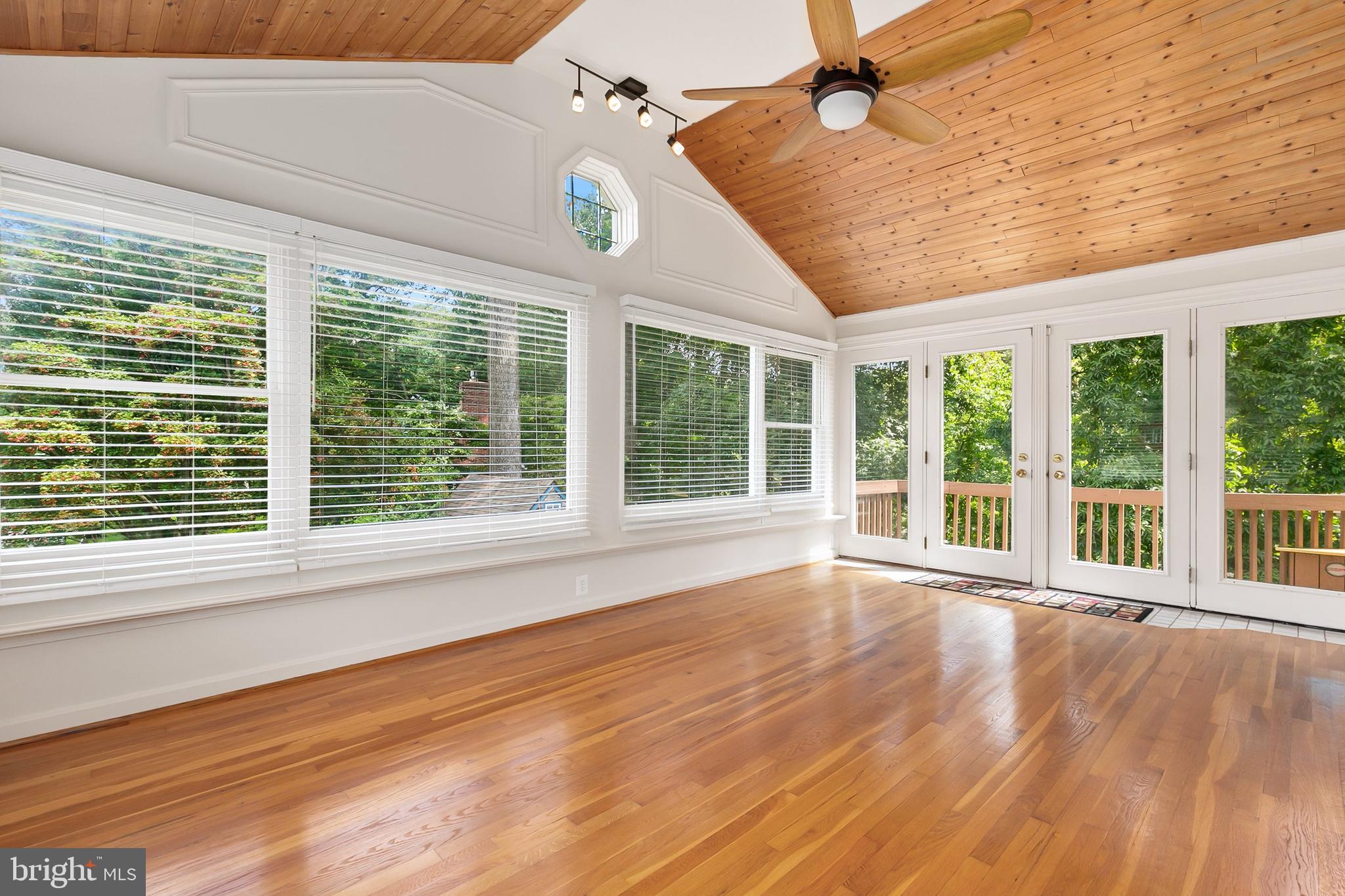 10601 Kinloch Road Silver Spring, MD 20903 - Photo 10 of 47 a view of an empty room with wooden floor and a window