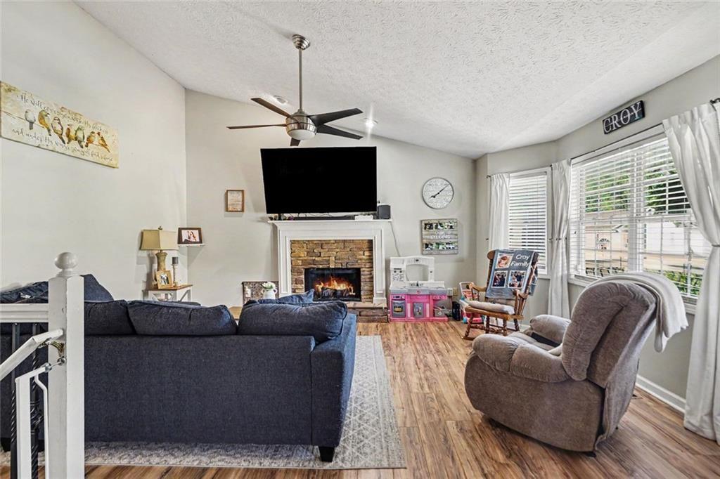 302 Fairview Lane Dallas, GA 30157 - Photo 5 of 26 a living room with furniture a flat screen tv and a fireplace