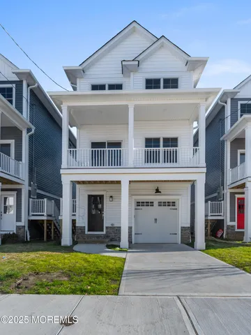 a front view of a house with a yard and a garage