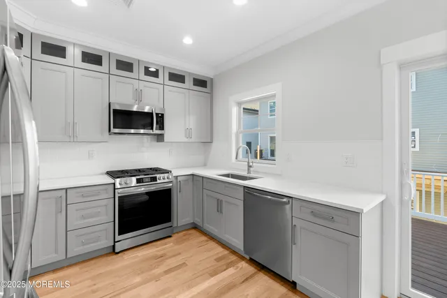 a kitchen with stainless steel appliances granite countertop a sink and stove top oven
