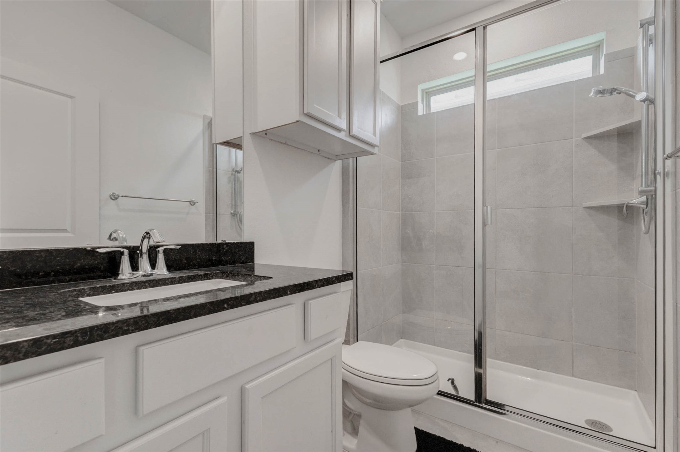 3711 Castle Rock Drive Rosenberg, TX 77469 - Photo 22 of 46 a bathroom with a granite countertop sink a toilet and a shower