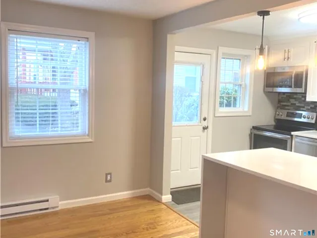 a view of a kitchen with wooden floor and a sink