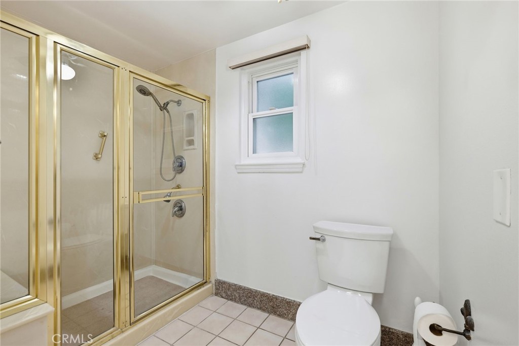 18233 Charlton Lane Porter Ranch, CA 91326 - Photo 20 of 40 a bathroom with a toilet and a shower