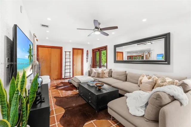 a living room with furniture fireplace and a large window