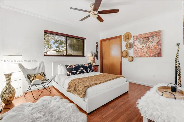 a bedroom with a bed and wall painting