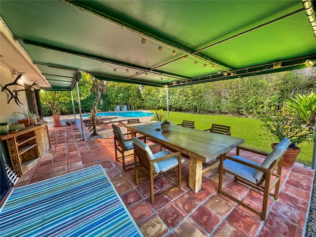 a backyard of a house with outdoor seating