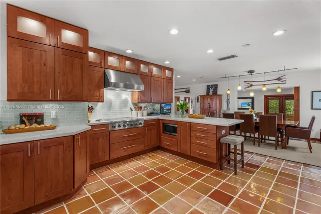a kitchen with granite countertop a sink stainless steel appliances and cabinets
