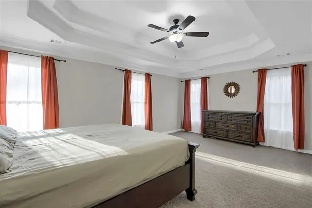 a bedroom with a bed a dresser and a window