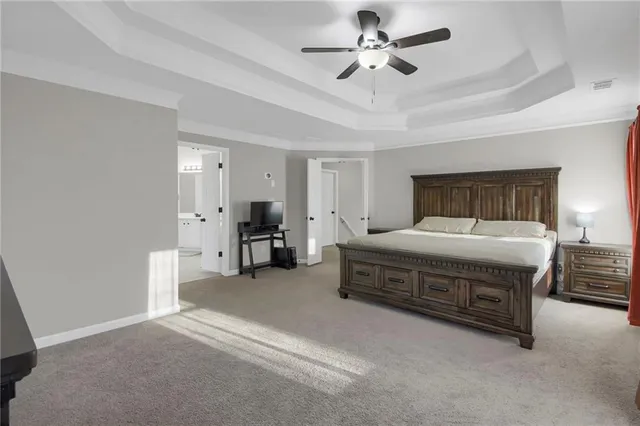 a spacious bedroom with a bed and a ceiling fan