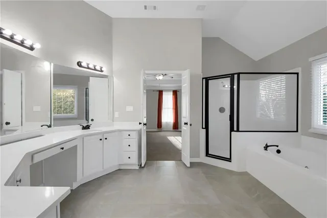 a large bathroom with a large tub and sink