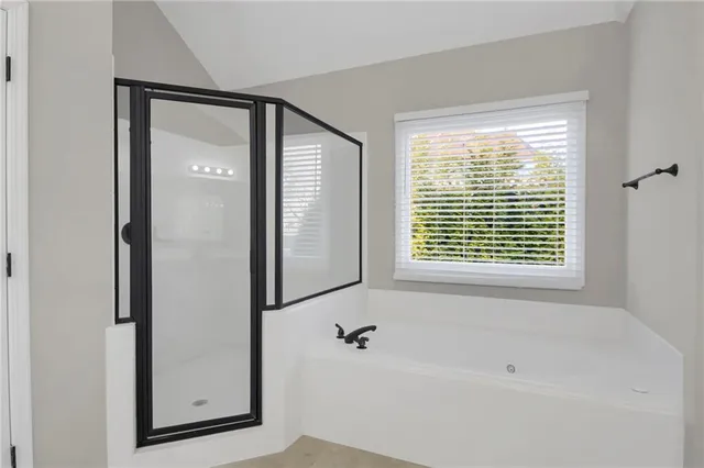 a bathroom with a bathtub and a shower