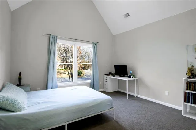 a bedroom with a bed and a desk