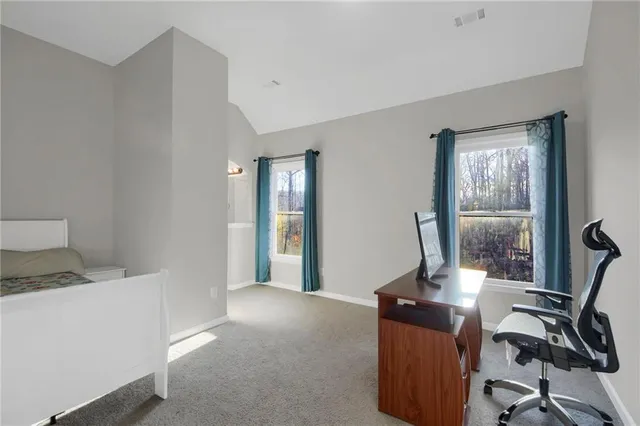 a living room with furniture and a floor to ceiling window