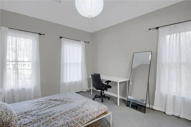 a bedroom that has a bed and chair