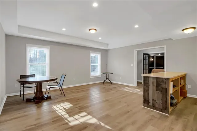 a view of a work space with furniture and wooden floor