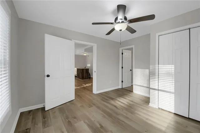 a view of empty room with wooden floor