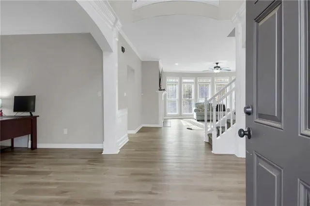 a view of empty room with wooden floor